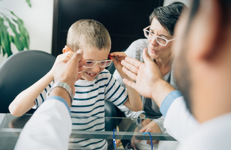 Child trying on glasses