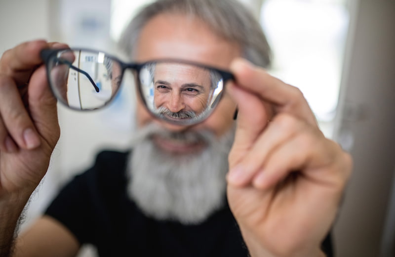 Senior man looking through glasses