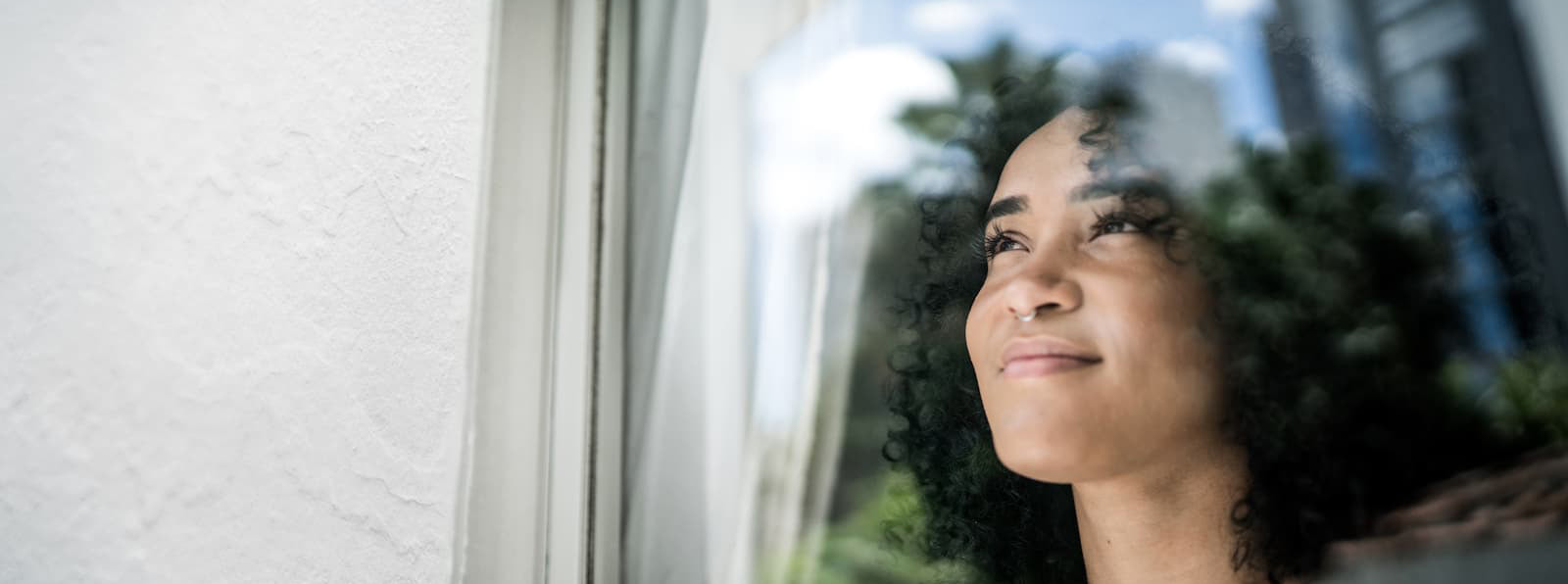 A woman looks out the window