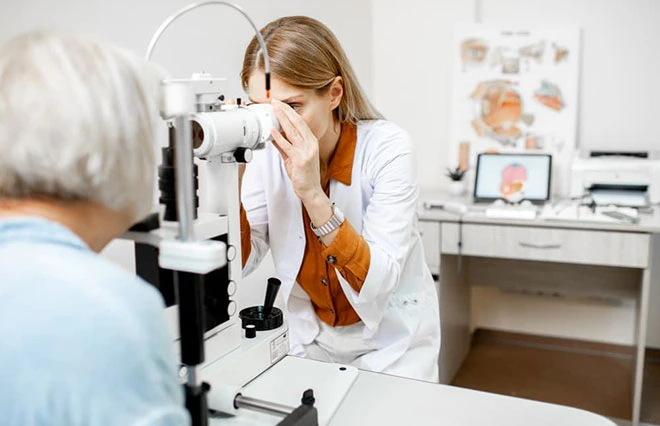 Female doctor giving a patient an eye exam