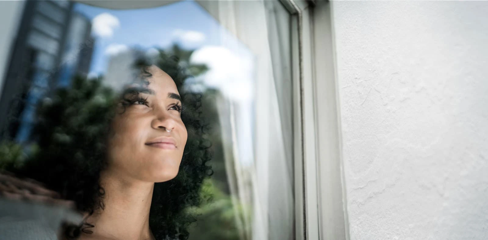 African American woman looking out a window
